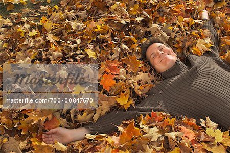 Man Lying on Pile of Leaves