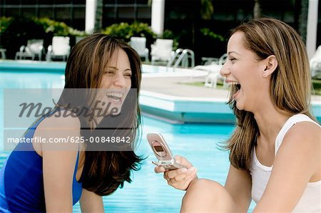 Close-up of two young women laughing