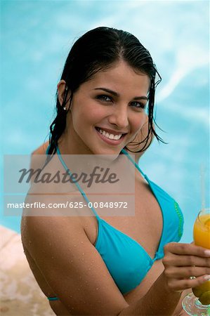 Portrait of a young woman holding a drink