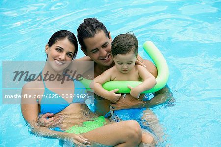 High angle view of parents with their son in a swimming pool