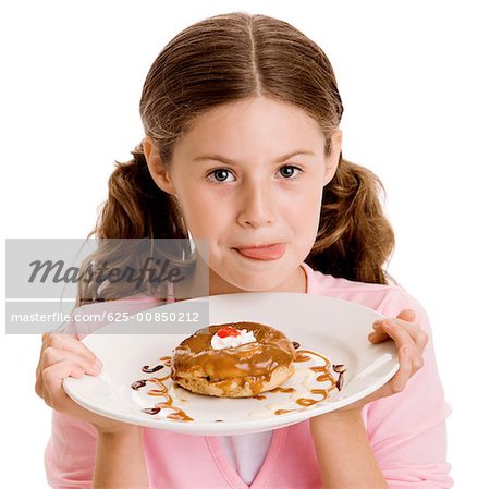 Portrait of a girl holding dessert in a plate