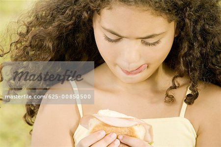 Close-up of a girl holding a burger