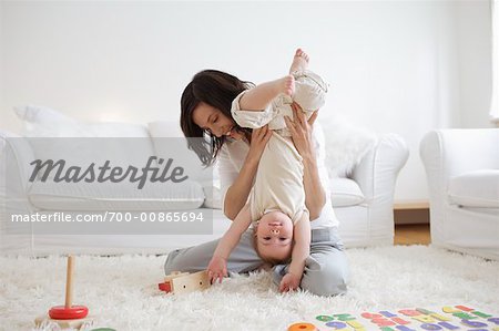 Woman Playing with Son in Living Room