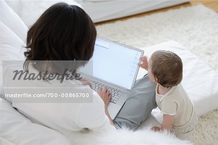 Mother and Baby with Laptop in Livingroom