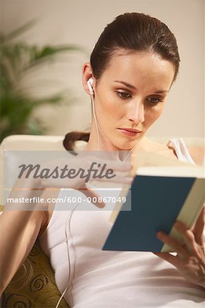 Woman Reading and Listening To Music