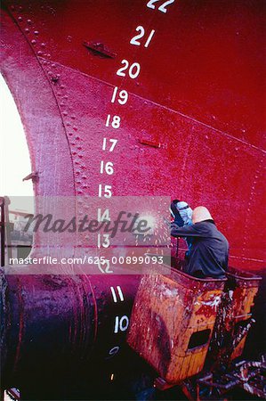 Rear view of a welder welding a tanker, Cebu, Philippines Rear view of a welder welding a tanker, Cebu, Philippines