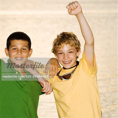Portrait of a boy and a teenage boy smiling