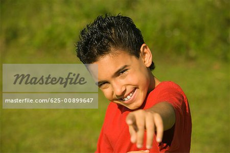 Portrait of a boy pointing forward