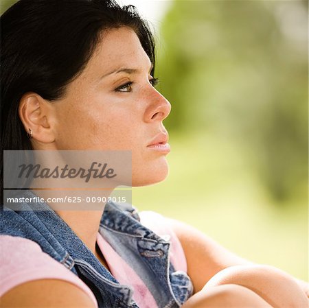 Side profile of a young woman looking serious