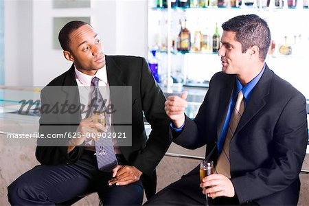 Close-up of two businessmen holding champagne flutes