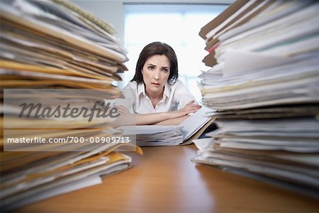 Businesswoman Surrounded By Paperwork