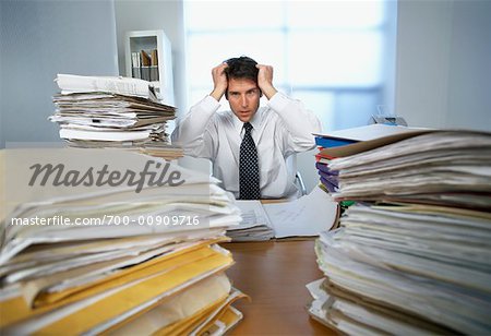 Businessman Surrounded By Paperwork