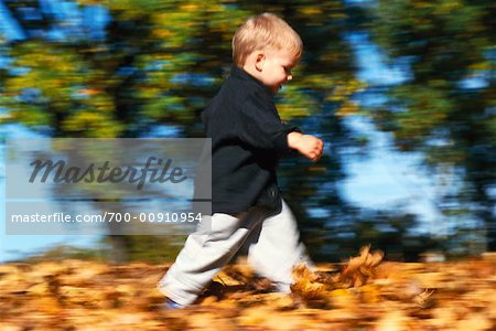 Child Walking through Leaves