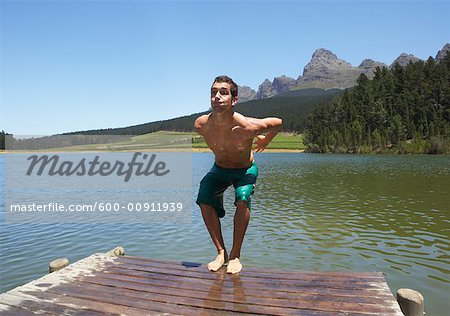 Man Jumping into Water from Dock