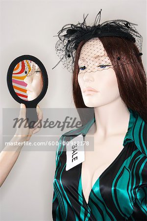 Woman Holding Mirror By Mannequin