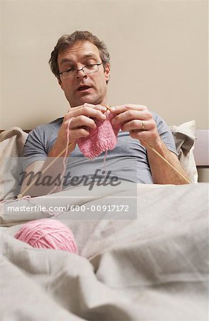 Man Knitting in Bed
