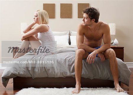 Couple Sitting on Bed