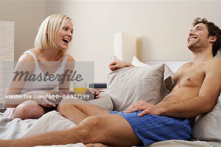 Woman Bringing Man Breakfast in Bed