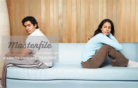 Couple Sitting With Backs to Each Other