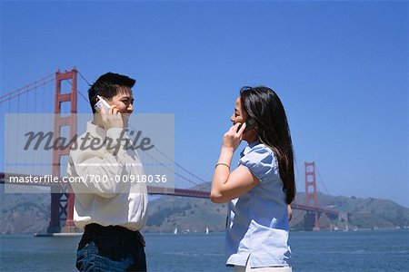 Couple on Cell Phones Outdoors, San Fransisco, California, USA