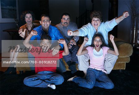 Family Watching Television And Cheering