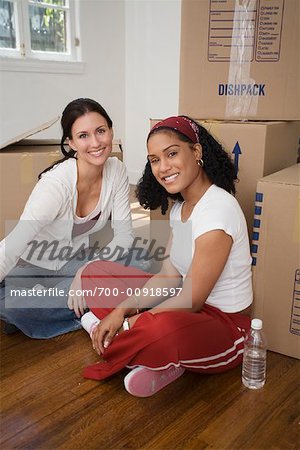People with Boxes In A New House