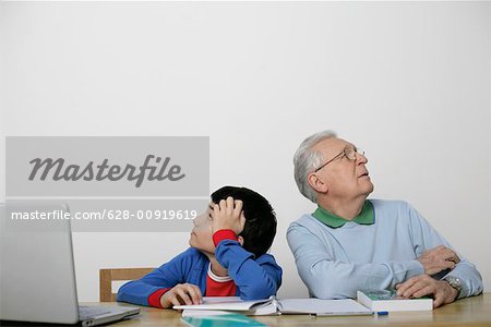 Dissatisfied boy and grandfather sitting back to back, fully_released