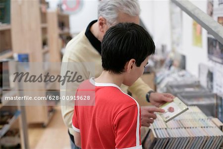 Grandfather and boy choosing CDs, fully_released