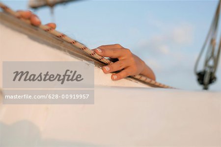 Woman on a sailboat, focus on hands