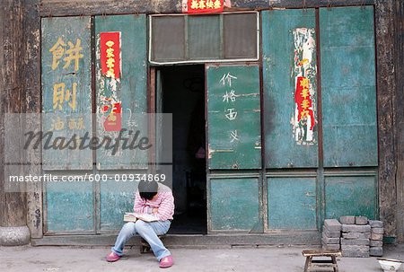 Person Reading Book Outdoors, Pingyao, China