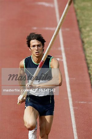 Male Pole Vaulter Sprinting Down the Track