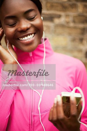 Woman Listening to Portable Audio Player