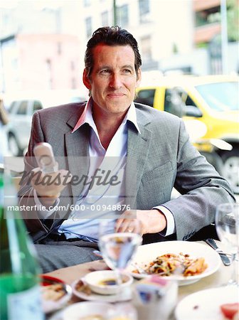 Businessman at Restaurant with Cellular Phone