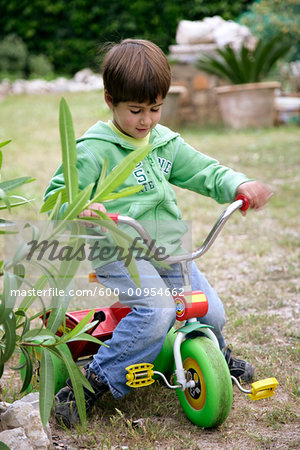 Boy Riding Tricycle