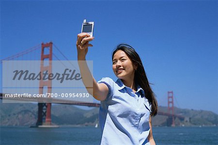 Woman Taking Self Portrait Near the Golden Gate Bridge, San Francisco, California, USA