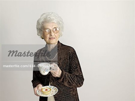 Senior woman with tea and cake