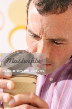 Man Looking in Coffee Cup
