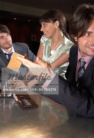 Businessmen and Woman in Bar
