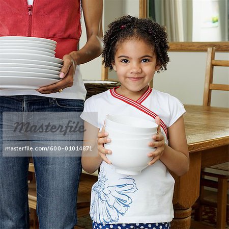 Mother and Daughter Holding Dishes