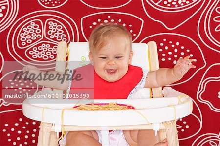Baby with Spaghetti in High Chair