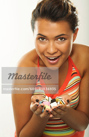 Portrait of Woman With Handful of Licorice Candy