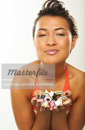 Portrait of Woman With Handful of Licorice Candy