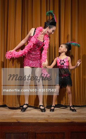 Woman and Girl Performing on Stage