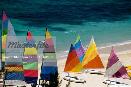 A cluster of colored sails stationed on a seashore, Nassau, Bahamas