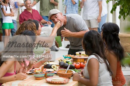 Woman Feeding man at Family Gathering