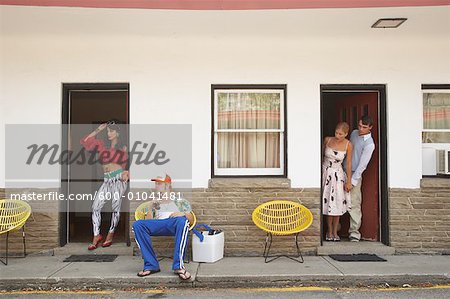 Couple Looking at Other Couple at Motel