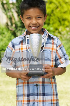 Portrait of Boy Holding Trophy