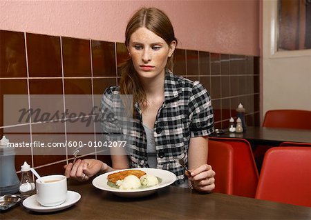 Woman Eating Dinner in Restaurant