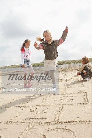 Children Playing Hopscotch on Beach