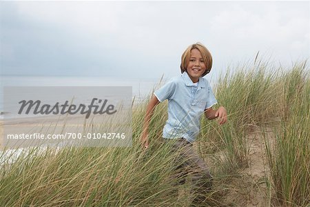 Boy in Long Grass on Beach